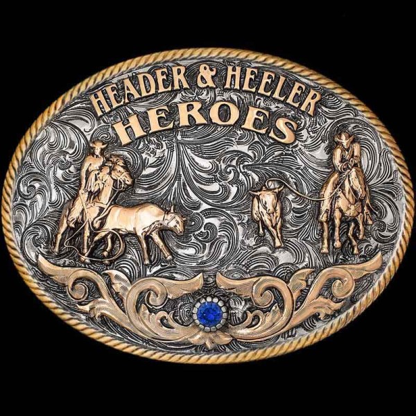"Our Clovis Classic Buckle captures the grit & dedication roping partners share, truly making them Header & Heeler Heroes. This Buckle is crafted on a German Silver base with an antique finish to give a rustic feel. It is detailed with a Jewe